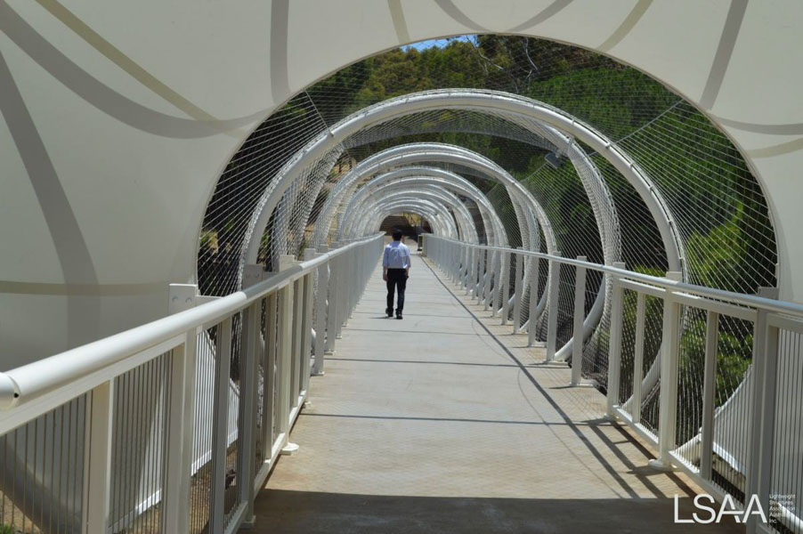 View along deck of enclosed Flinders University Pedestrian Bridge