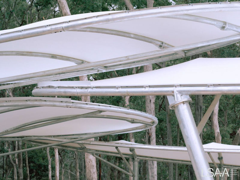 five elliptical tensile membrane canopies being installed